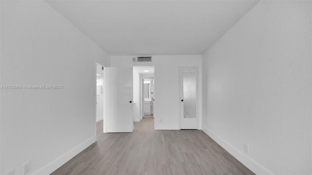 unfurnished room with light wood-type flooring