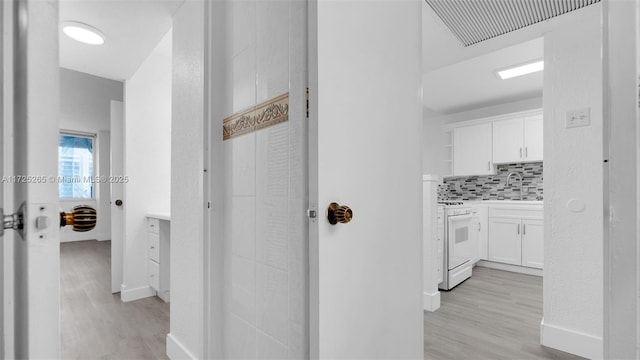 hall featuring light wood-type flooring and sink