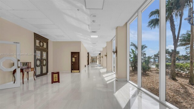 corridor featuring floor to ceiling windows and plenty of natural light