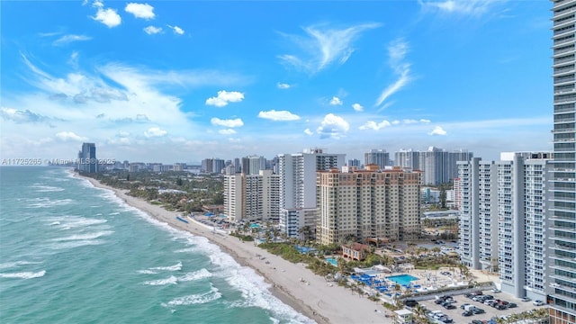 drone / aerial view featuring a beach view and a water view