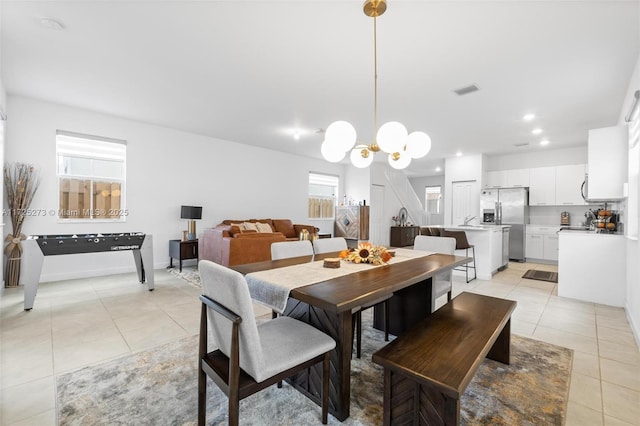 dining room with an inviting chandelier and light tile patterned flooring