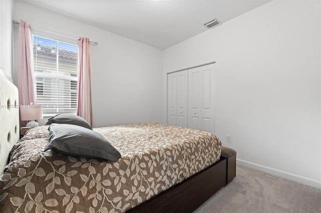 bedroom featuring a closet and light colored carpet