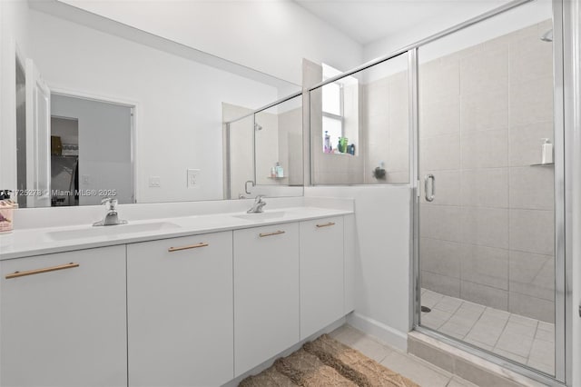 bathroom with tile patterned flooring, a shower with shower door, and vanity