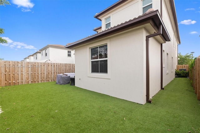 rear view of property featuring a lawn