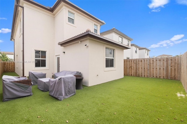 back of house with a lawn