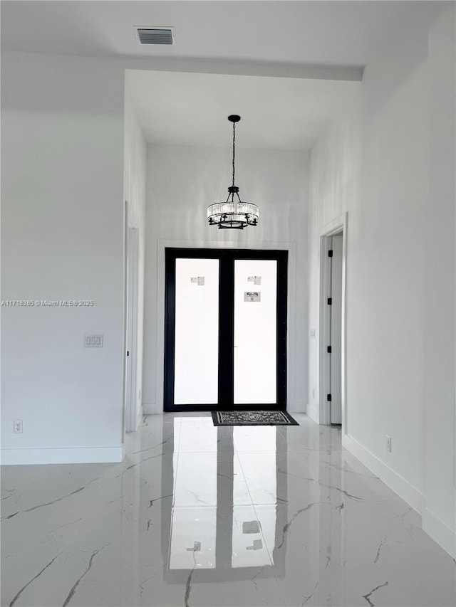 foyer entrance with a chandelier