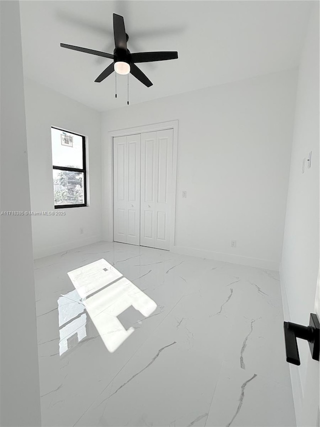 interior space with ceiling fan