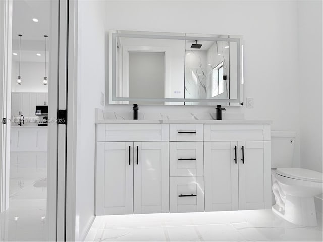 bathroom with toilet, walk in shower, and vanity