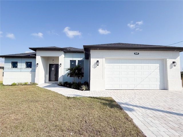 view of front of home with a front lawn and a garage