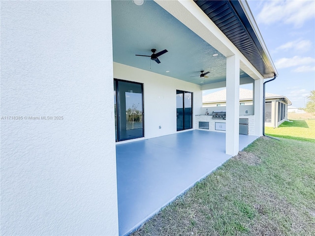 view of patio featuring an outdoor kitchen, ceiling fan, and a grill