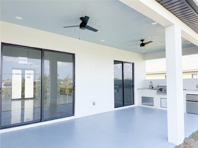 view of patio / terrace featuring exterior kitchen and ceiling fan