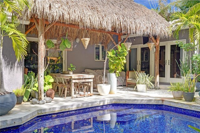 view of pool with a patio area and french doors