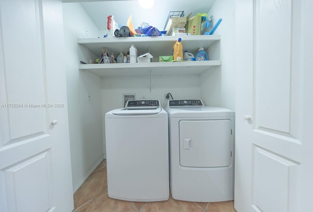 laundry room featuring washer and dryer and light tile patterned flooring