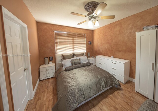 bedroom featuring ceiling fan and light hardwood / wood-style floors