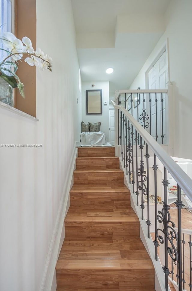 stairway featuring hardwood / wood-style floors