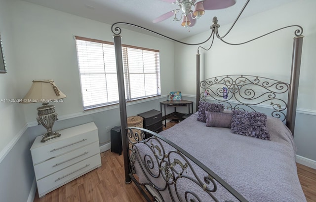 bedroom with ceiling fan and light wood-type flooring