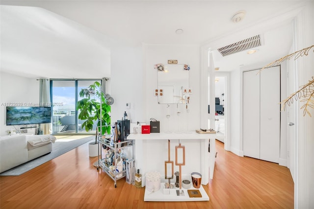 kitchen featuring hardwood / wood-style flooring and a wall of windows