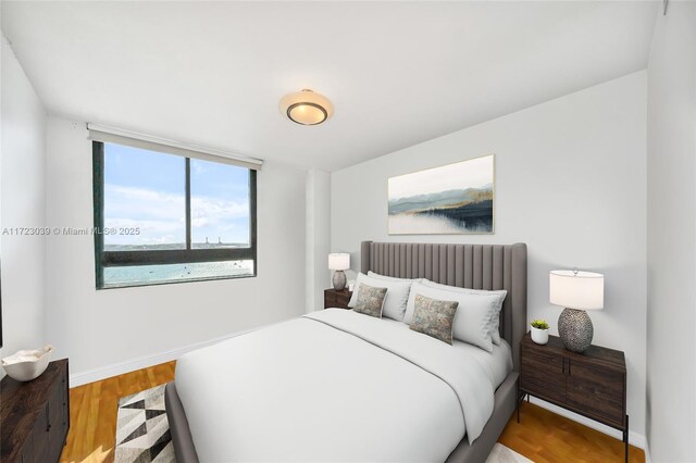 1330 W Ave Unit 1904, Miami Beach, FL 33139 - bedroom featuring baseboards and wood finished floors