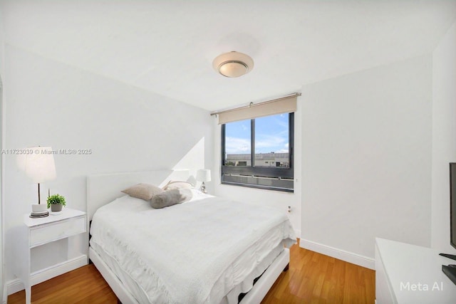 bedroom with wood-type flooring