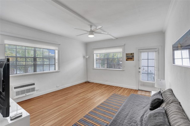 unfurnished living room with crown molding, a wall mounted air conditioner, a wealth of natural light, and light hardwood / wood-style flooring