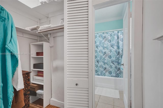 spacious closet with light tile patterned floors