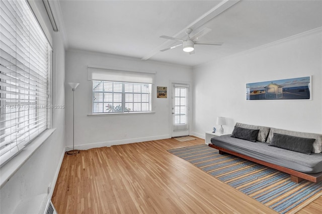 living room with wood-type flooring, ceiling fan, and crown molding