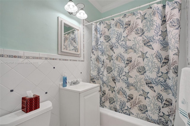 full bathroom with toilet, tile walls, ornamental molding, shower / bathtub combination with curtain, and vanity