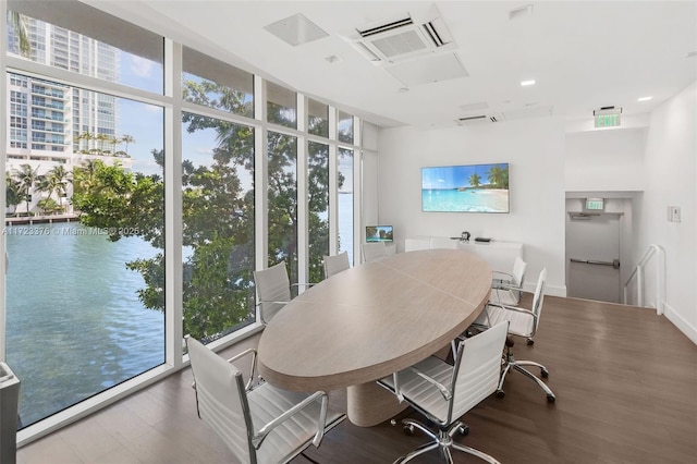 dining room with a wall of windows, baseboards, and wood finished floors