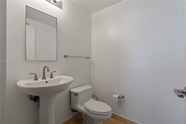 bathroom featuring toilet and tile patterned floors