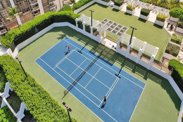 view of tennis court featuring fence