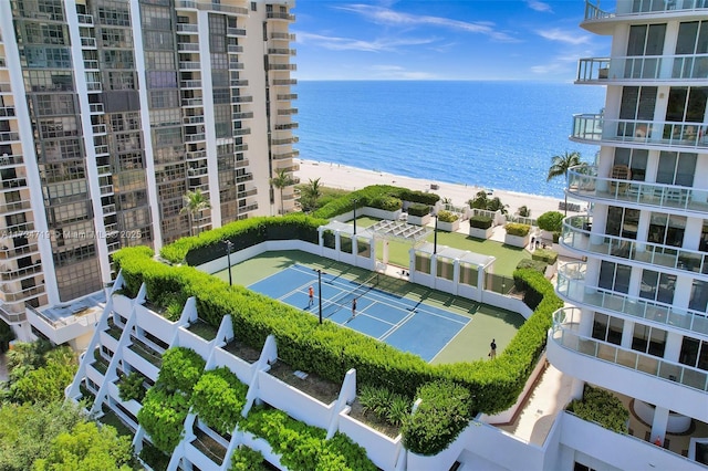 birds eye view of property featuring a water view and a beach view