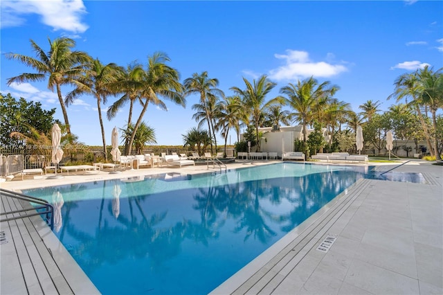 pool featuring an outdoor living space and a patio