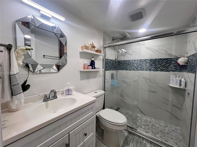 bathroom with walk in shower, vanity, and toilet