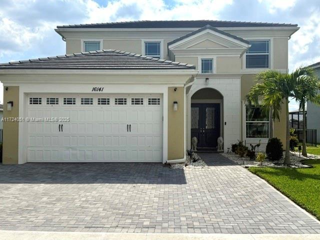 view of front facade with a yard and a garage