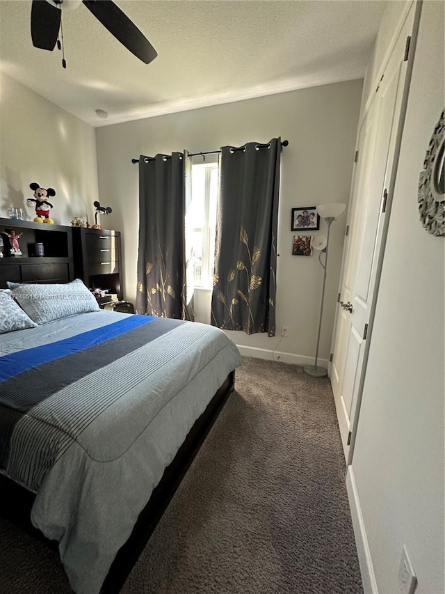 carpeted bedroom featuring ceiling fan and a textured ceiling