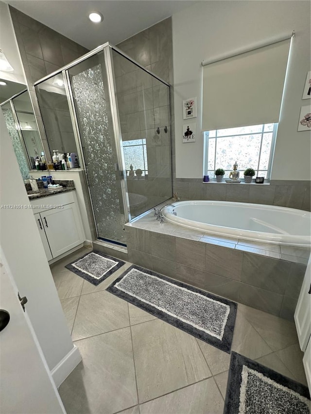 bathroom featuring vanity, separate shower and tub, and tile patterned flooring