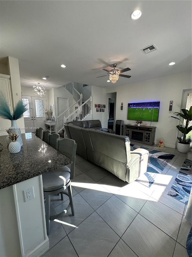 tiled living room with ceiling fan