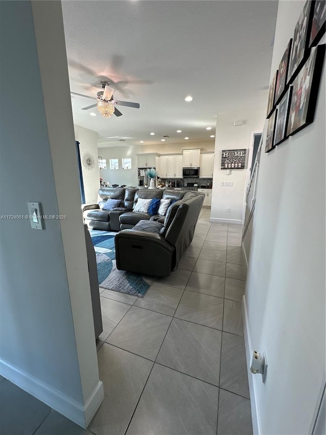 tiled living room featuring ceiling fan