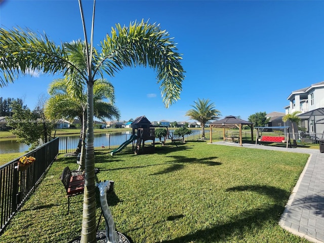 view of yard featuring a playground, a gazebo, and a water view