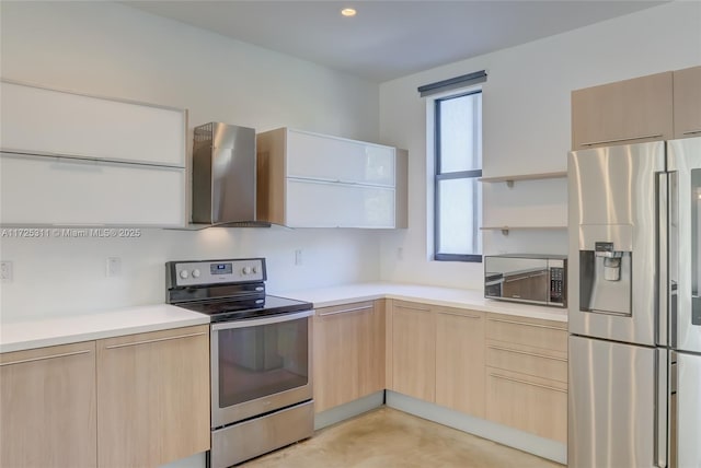 kitchen with wall chimney exhaust hood, stainless steel appliances, and light brown cabinetry