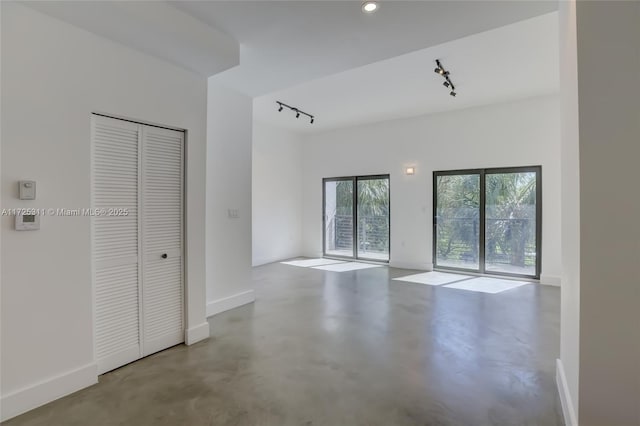 unfurnished room with track lighting