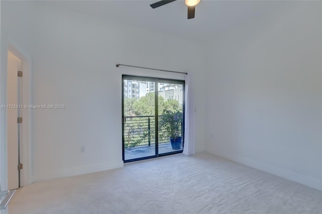 carpeted spare room with ceiling fan