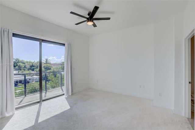 carpeted spare room with ceiling fan