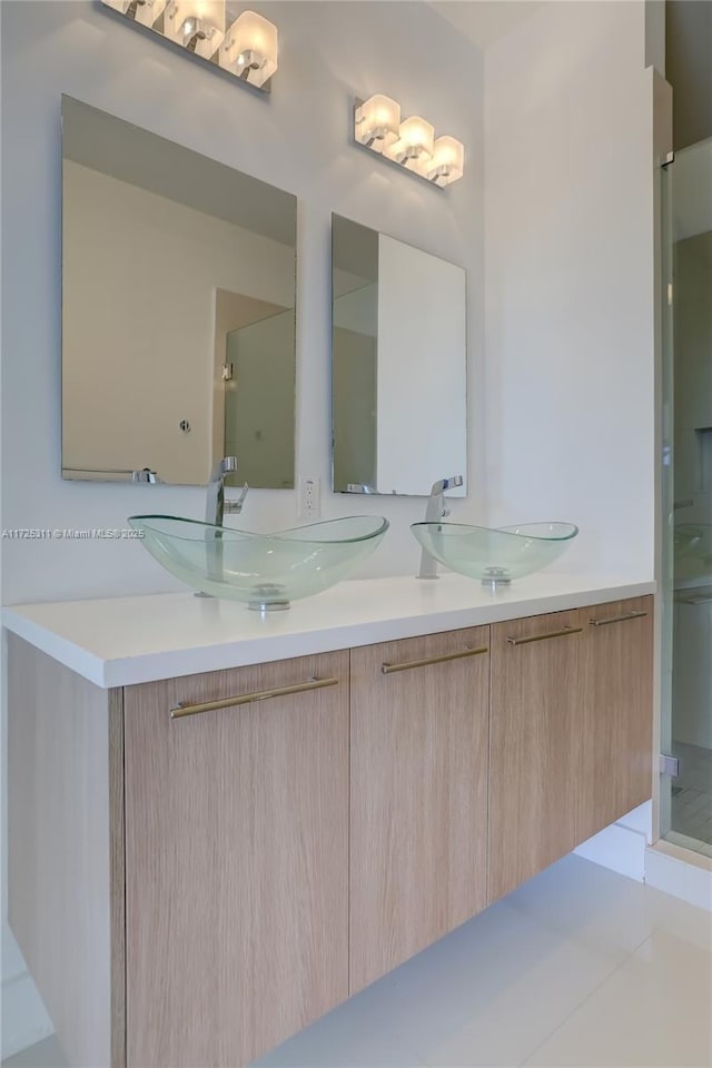 bathroom with vanity and a shower with shower door