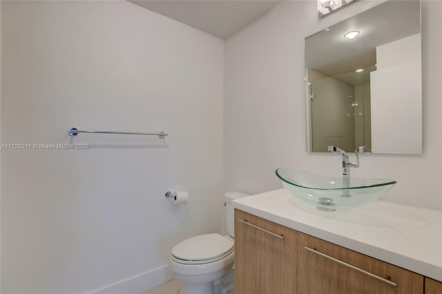 bathroom with vanity, toilet, and an enclosed shower