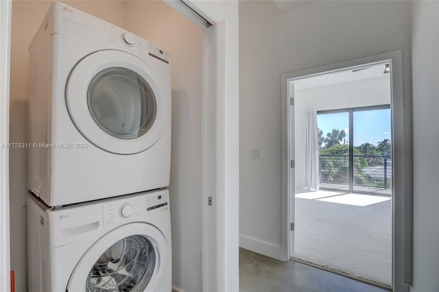 clothes washing area with stacked washer / dryer