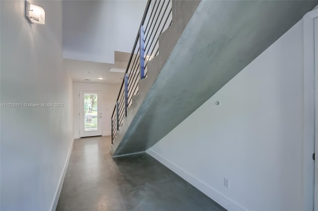 stairway featuring concrete floors