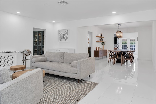 living room featuring french doors and light tile patterned flooring