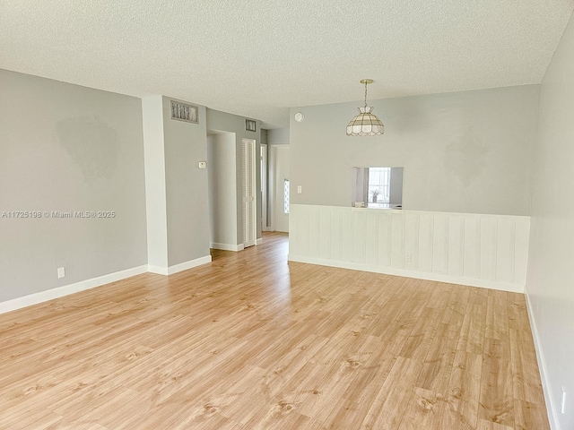 1000 NE 14th Ave Unit 404, Hallandale Beach, FL 33009 - empty room featuring light wood-type flooring, a textured ceiling, and baseboards