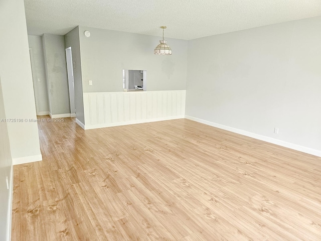 1000 NE 14th Ave Unit 404, Hallandale Beach, FL 33009 - unfurnished room featuring light wood finished floors, a textured ceiling, baseboards, and a smoke detector